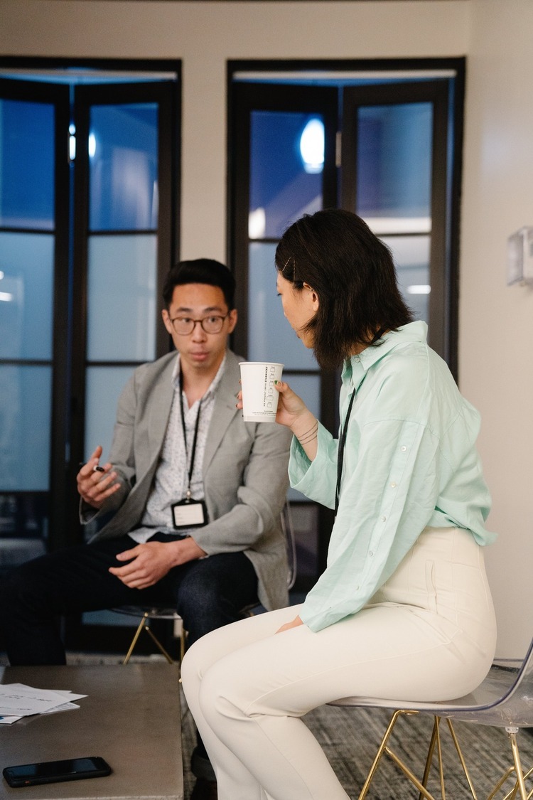 Two people at work talking