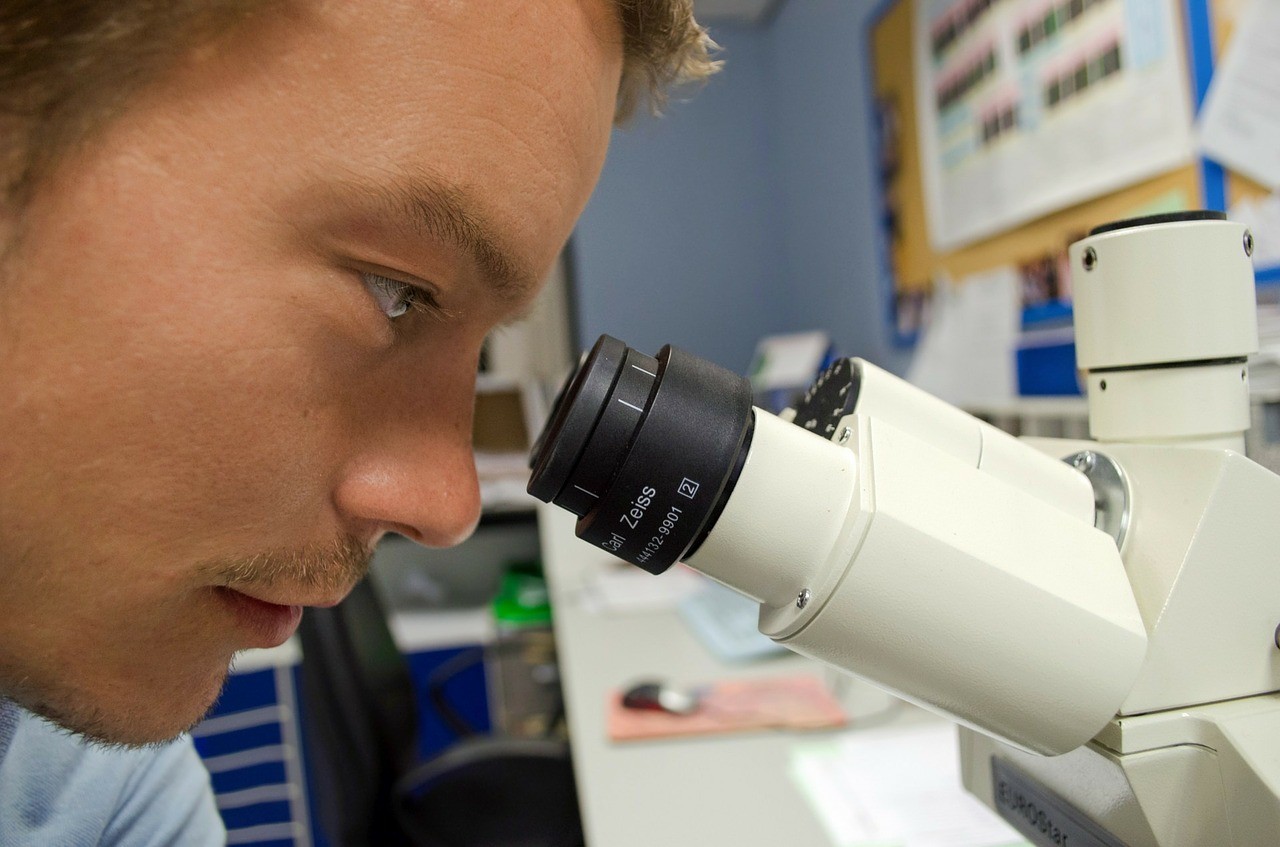 Person looking into microscope